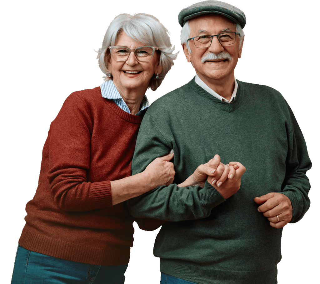 Smiling Elderly Couple in Sweaters Posing Arm in Arm at an Independent Living Community