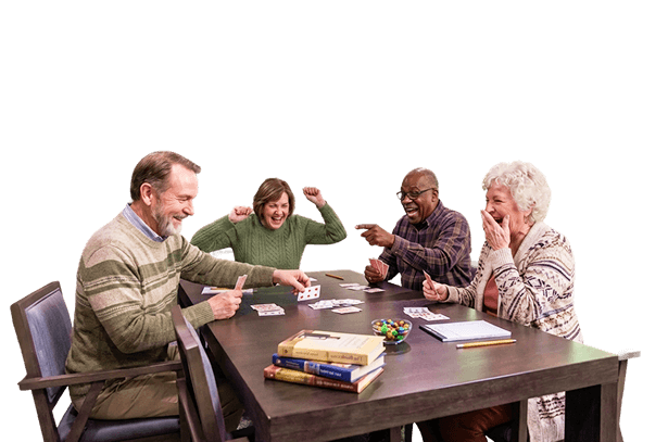 Four Elderly Friends Playing a Lively Card Game at an Independent Living Facility