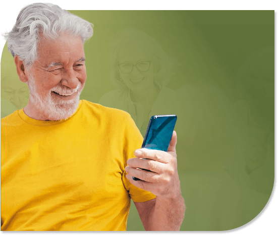 Smiling Elderly Man Reading His Smartphone in Independent Living Smiling Elderly Man Reading His Smartphone in Independent Living