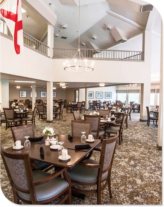 Spacious Dining Room with Round Tables and Elegant Chandelier at an Independent Living Facility Spacious Dining Room with Round Tables and Elegant Chandelier at an Independent Living Facility